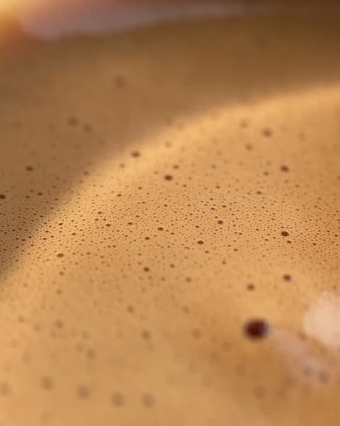 Close-up of the crema on a glass of espresso